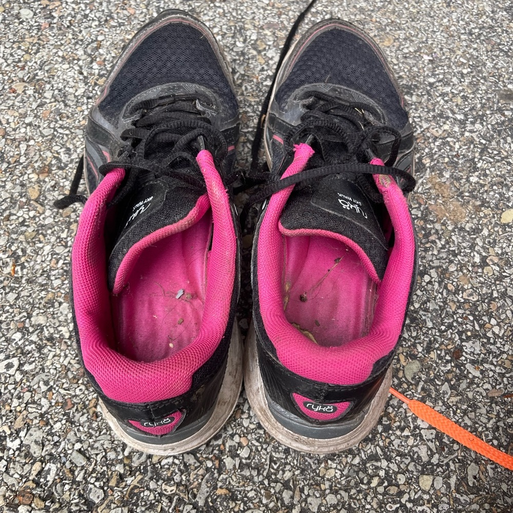 Well worn women’s pink black sneakers